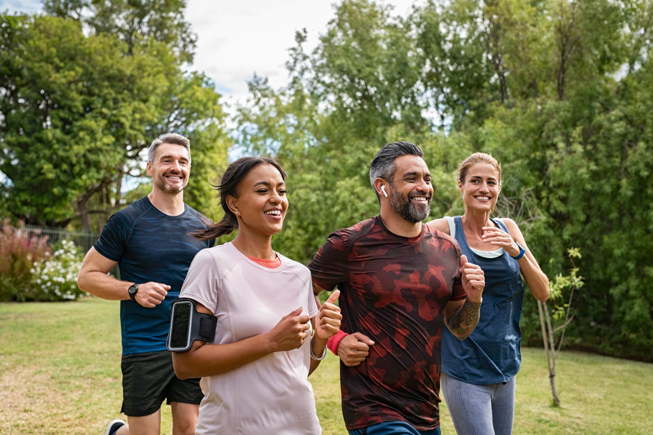 Group of adults jogging and smiling